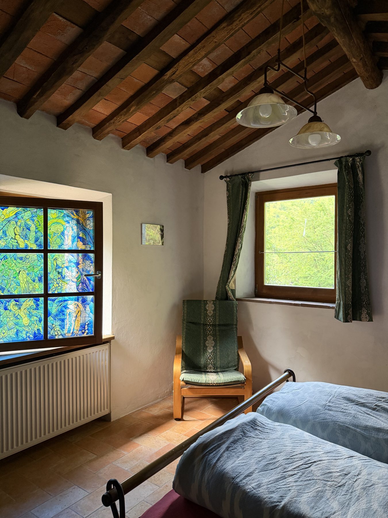 Camera del Mulino Verde con travi in legno e vetrata colorata